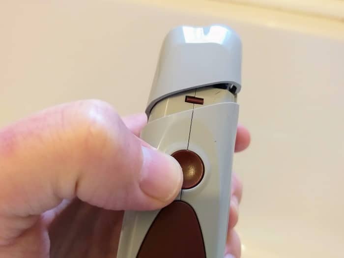 pressing side button of Andis ProFoil shaver