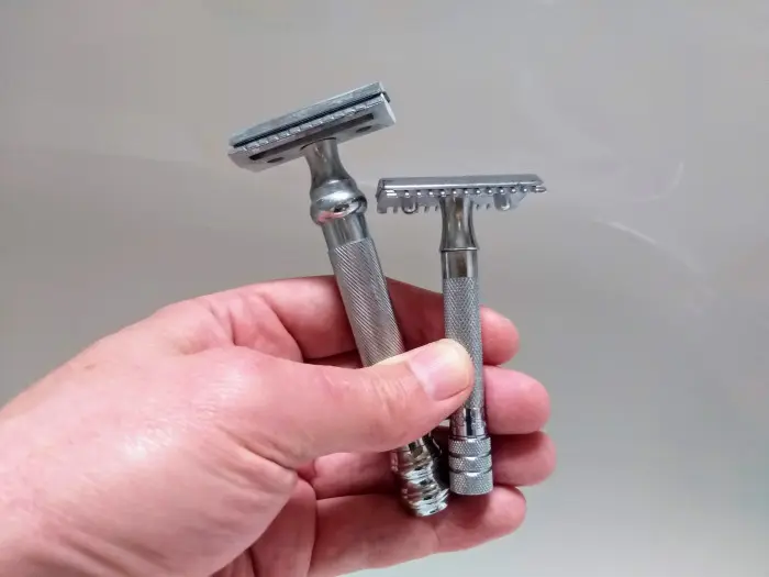 Parker 98r and Merkur 15c held in hand