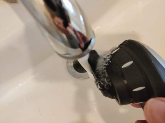 cleaning the Phillips qc5570 hair clipper under the tap