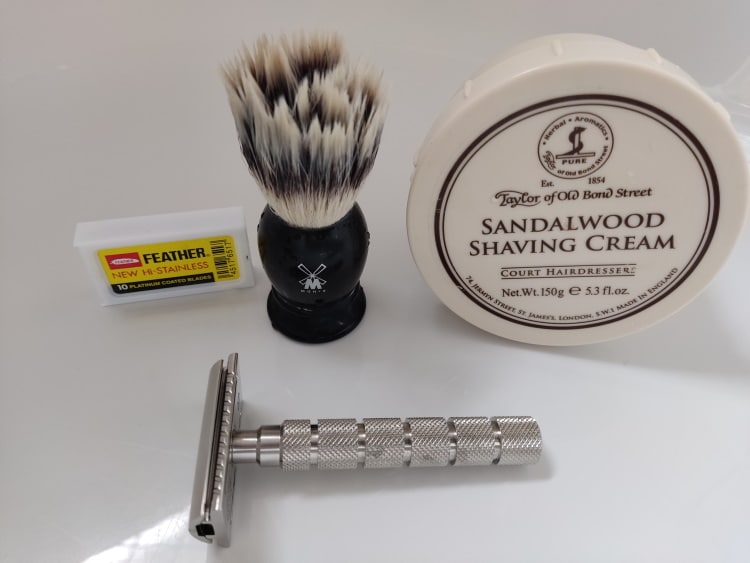 tub of Taylor of bond street sandlewood shaving cream with razor and brush