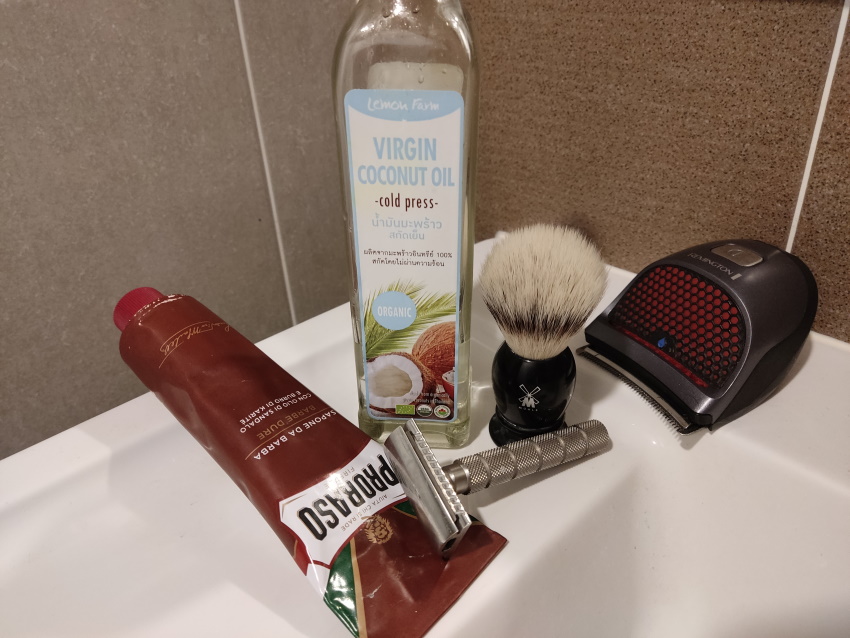 coconut oil with safety razor and shaving brush and head trimmer
