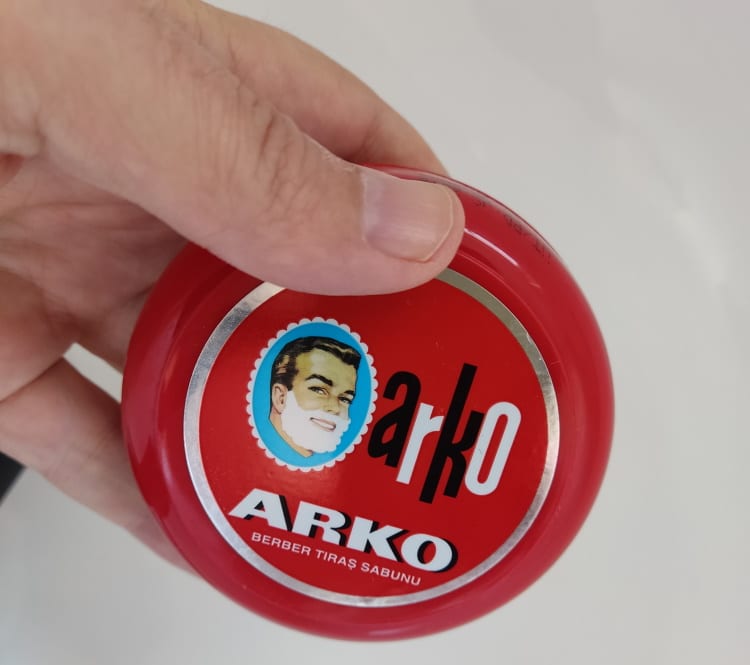 close up Arko shaving bowl soap held in hand