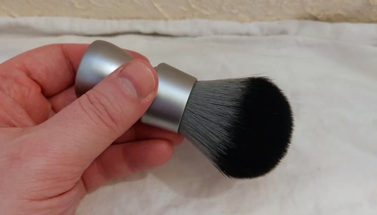 holding a Yaqi M150801 Shaving Brush to show the size