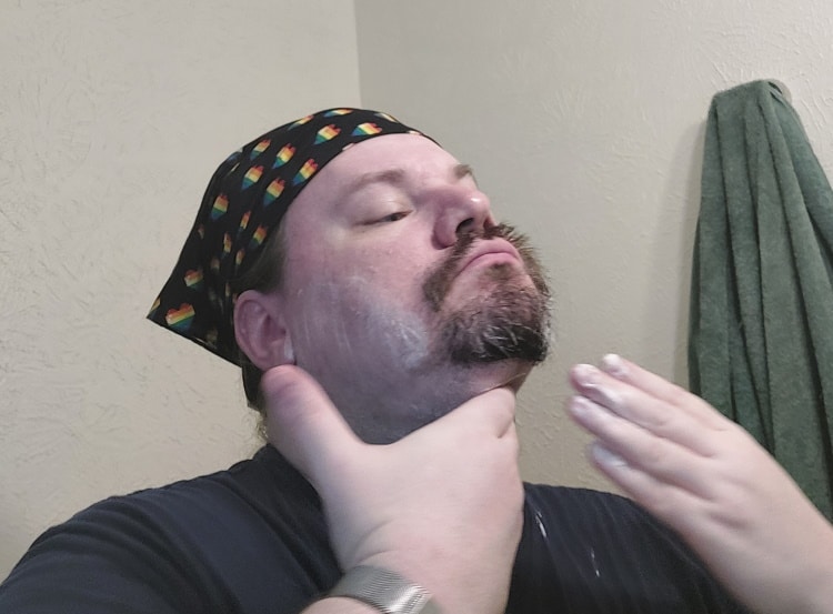 author applying pre shave cream before shaving with a shavette razor