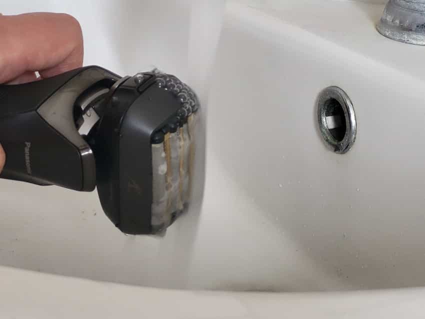 close up of rinsing the Panasonic Arc 6 shaver under the tap