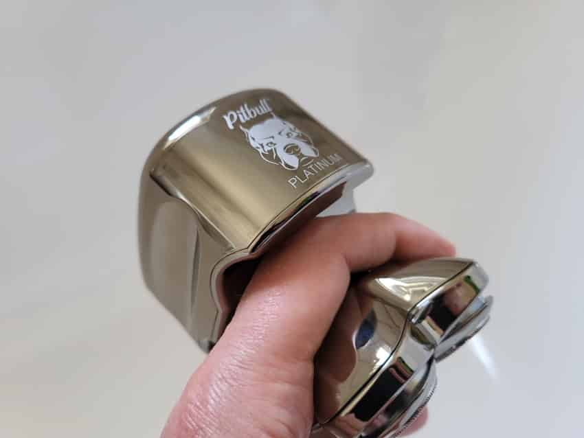 cupping the Skull Shaver Pitbull Platinum PRO in between the fingers