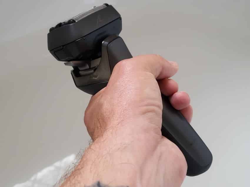 holding the Panasonic Arc 6 shaver to show how it looks