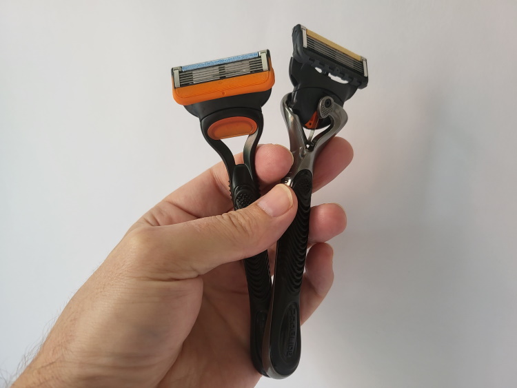 Gillette Fusion5 razor and Proglide held in hand next to each other