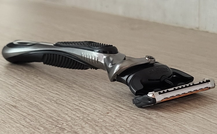 Gillette ProGlide razor with modern wooden background with blade attached