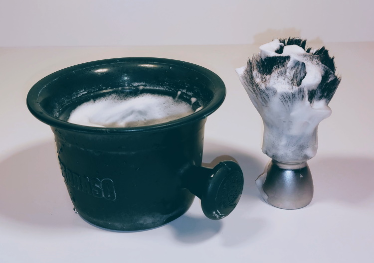 classic shaving soap in a proraso shaving mug and yaqi shaving brush with lather