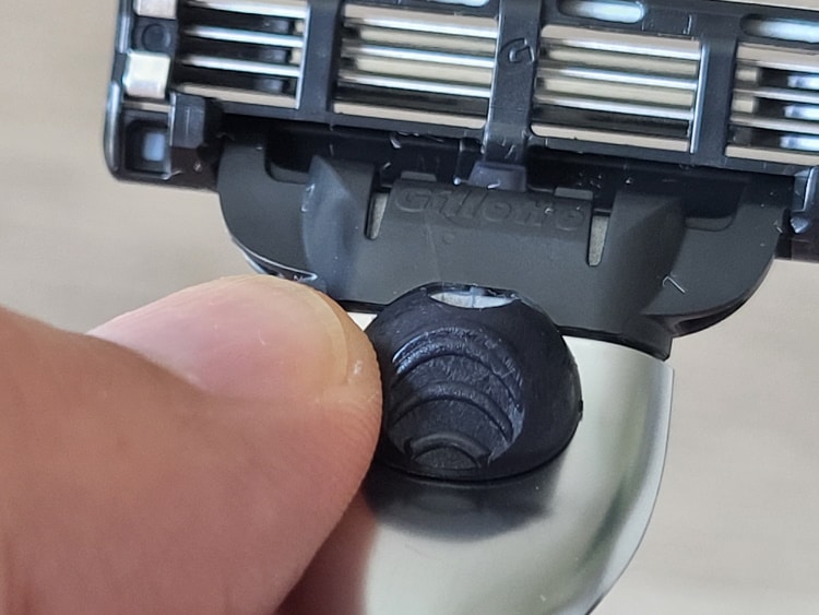 close up of Gillette Mach3 razor button to detach blade