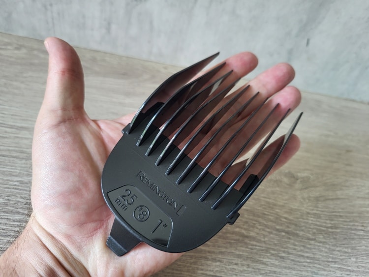 close up of Remington HC3400 largest 1 inch (25mm) clipper comb on a persons hand