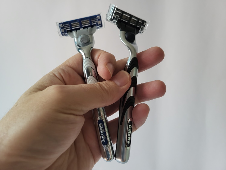 holding the Gillette Mach3 and Mach3 Turbo in the hand together