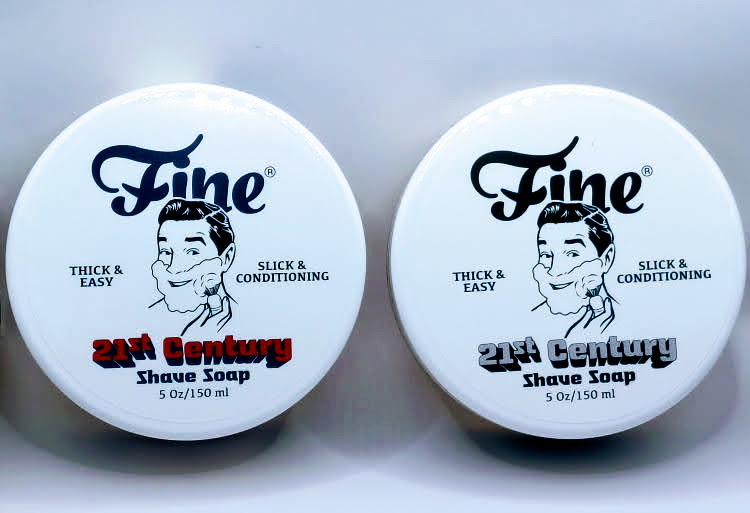 Fine Accoutrements Shaving Soap American Blend and Platinum standing next to each other