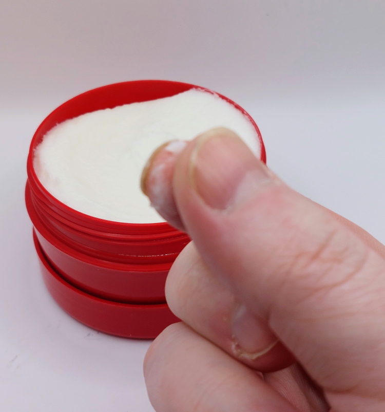 feeling texture of Cello almond shaving soap between fingers