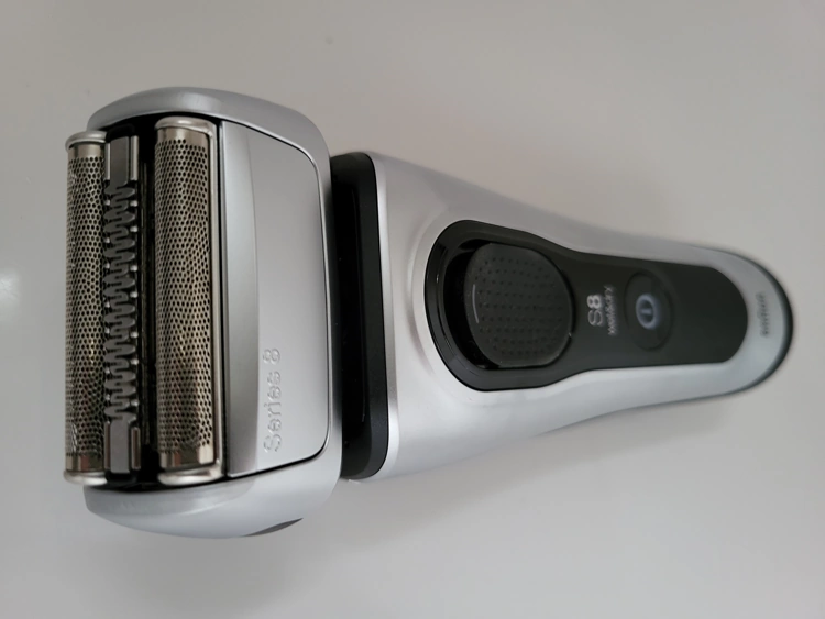 Braun Series 8 8467cc lying on its side with close up of shaver head