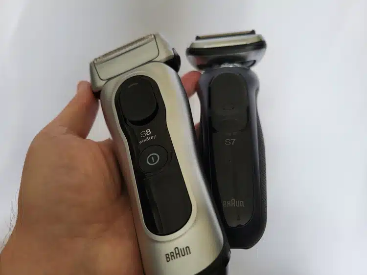 Braun Series 8 and Braun Series 7 shavers held in the hand next to each other to compare