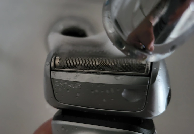 close up of cleaning the Braun Series 8 8467cc shaver under a running tap