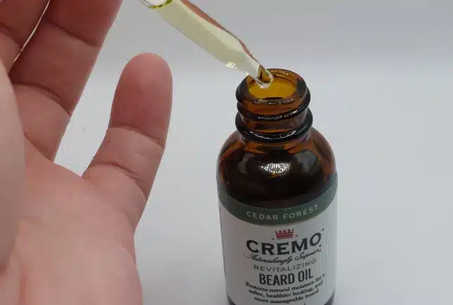 drawing up oil from the Cremo Cedar Forest Beard Oil dropper