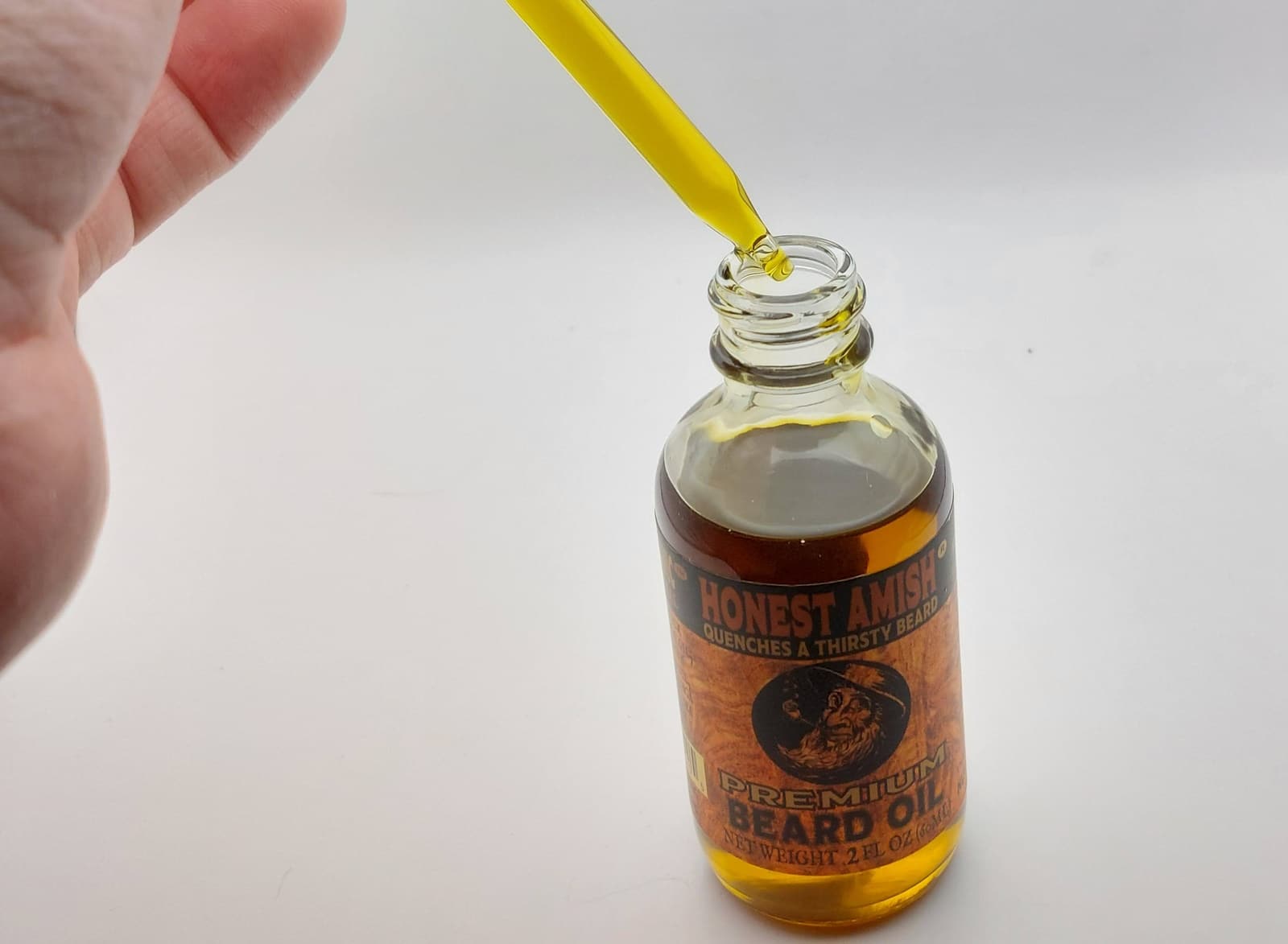 using the dropper of the Honest Amish Premium Beard Oil bottle