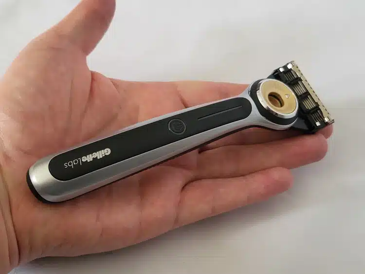 GilletteLabs Heated razor laying on the palm of the hand to show its size