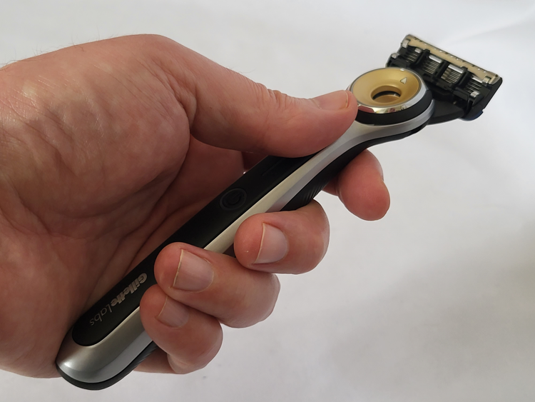 holding the GilletteLabs Heated razor to show where the blade can be released