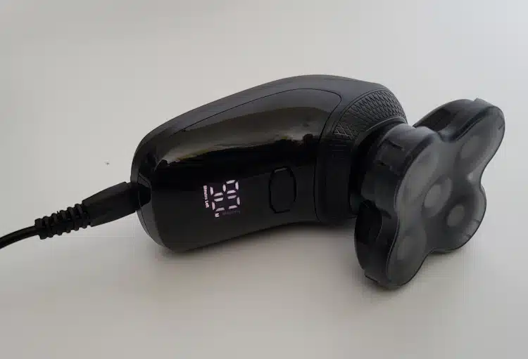 the Groomie BaldiePro Head Shaver plugged in charging