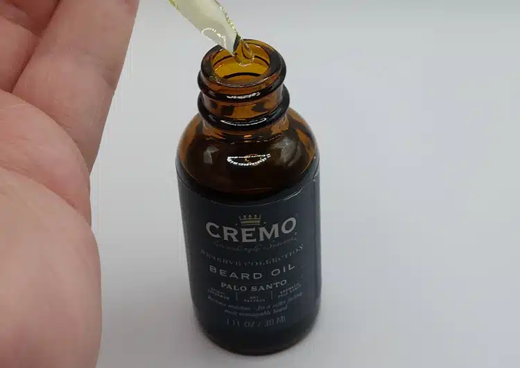 close up of dropper amount taken from Cremo Palo Santo Beard Oil bottle