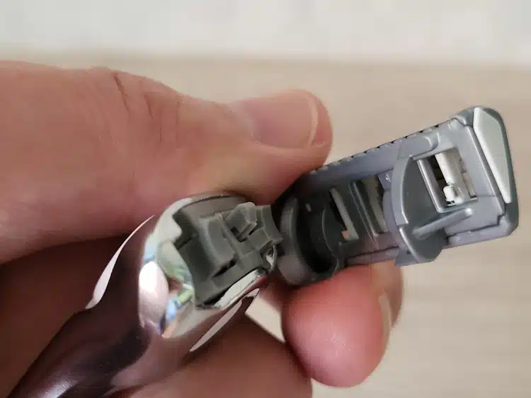 close up of the Schick Quattro Titanium cartridge blade parting from the handle and the mechanism