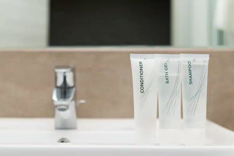 hair conditioner tube with other tubes in bathroom that is ready to use for shaving if needed