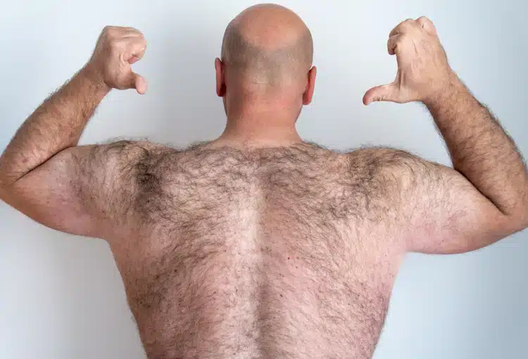 rear view of man with a hairy back and shaved bald head