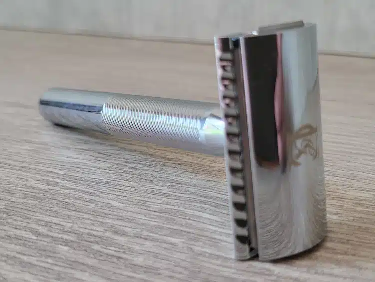 King C. Gillette Safety Razor on wooden shelf facing forwards at an angle
