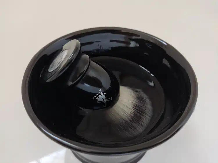 Muhle shaving brush in water and shaving bowl before lathering