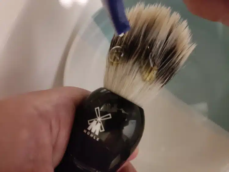 adding shampoo on shaving brush for cleaning