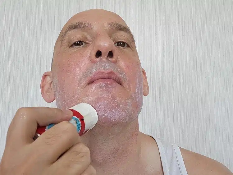 applying Arko shaving soap stick to the face