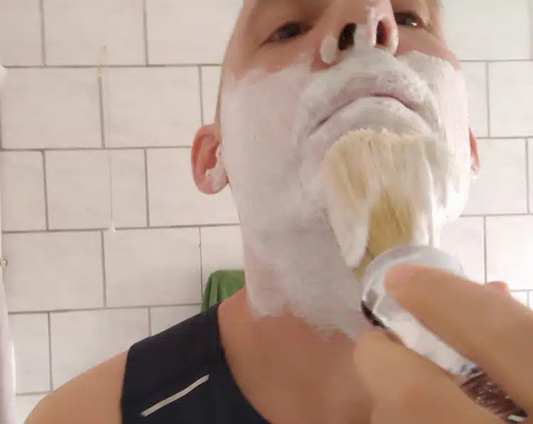 author enjoying shaving with a brush and shaving lather in bathroom