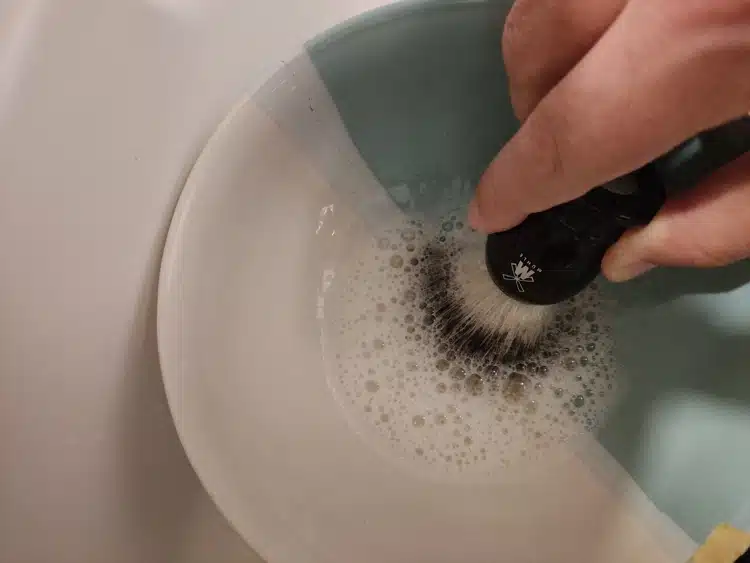 shampooing a shaving brush inside a bowl