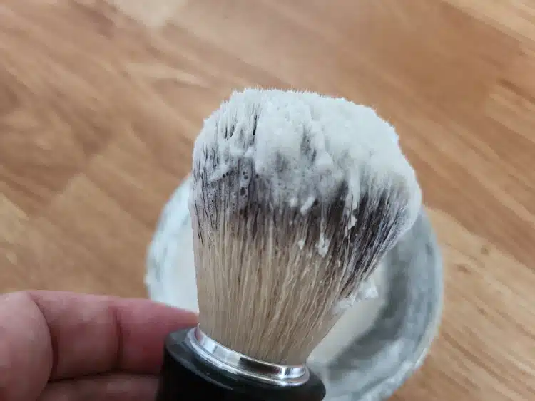 shaving brush loaded with shaving soap ready to lather
