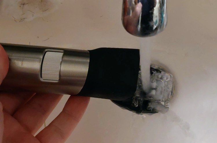 cleaning the Philips Norelco Series 9000 Prestige Beard Trimmer under the tap