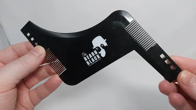 The BEARD BLACK Beard Shaping Tool held to display its design