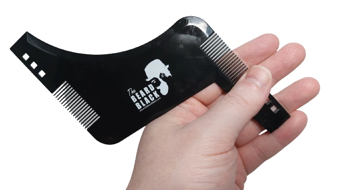 The BEARD BLACK Beard Shaping and Styling Tool held to show how it looks held in the hand