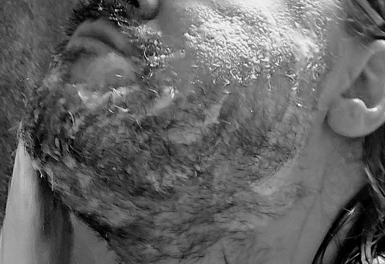 close up of Grave Before Shave Beard Wash Shampoo lathered on the beard