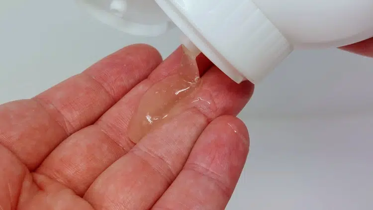 squeezing some Billy Jealousy Beard Wash from the bottle onto the hand