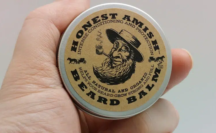 Honest Amish Beard Balm tub held in hand