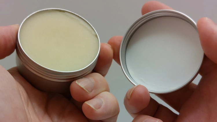 Honest Amish Beard Balm tub in the hand opened ready to use