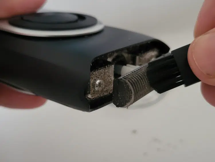 cleaning the Braun MobileShave M-90 shaver with its brush