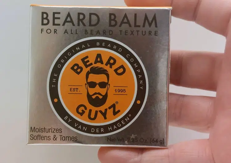 close up holding the Beard Guyz Beard Balm inside its box