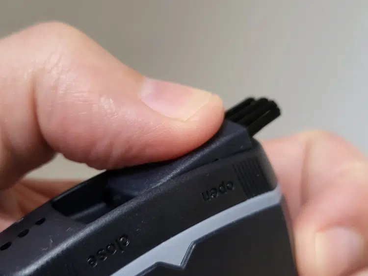 close up of removing the Braun MobileShave M-90 brush from the bottom of the shaver
