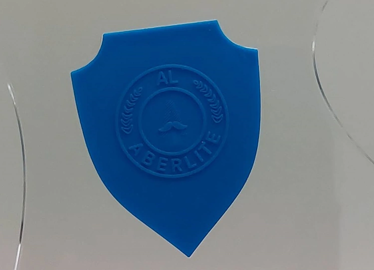 close up of the Aberlite Clear Shaper rubberized shield-like logo