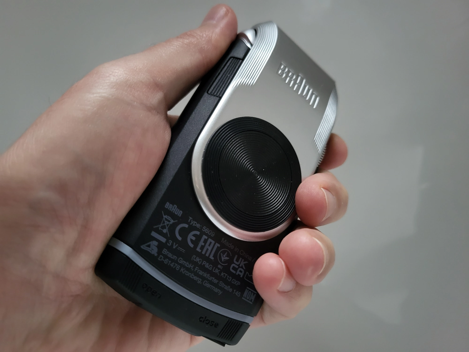 holding the Braun MobileShave M-90 shaver to display how it fits in the hand